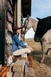© ADDICTIVE STOCK - Woman with horses on porch of house