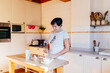 © ADDICTIVE STOCK - Mature woman preparing breakfast in home kitchen