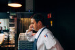 © ADDICTIVE STOCK - Chef speaking on phone in kitchen