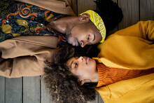Sensual Black Couple In Colorful Clothes Lying Ace To Face