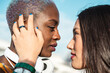 © ADDICTIVE STOCK - Couple of multiethnic lesbian women looking at each other