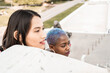 © ADDICTIVE STOCK - Stylish multiethnic couple of women in city