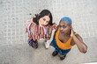 © ADDICTIVE STOCK - Stylish multiethnic couple of lesbian women in city