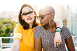 © ADDICTIVE STOCK - Stylish couple of multiracial lesbian women embracing in street