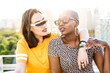 © ADDICTIVE STOCK - Stylish couple of multiracial lesbian women embracing in street