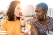 © ADDICTIVE STOCK - Multiethnic couple of cool lesbian women drinking cocktails