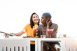 © ADDICTIVE STOCK - Multiethnic couple of cool lesbian women drinking cocktails