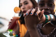 © ADDICTIVE STOCK - Multi ethnic lesbian couple relaxing with cocktails