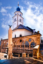 Kranj, Slovenia, Church Of The Holy Rosary With Colonnade And Fountain Topped By A Rooster