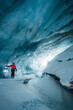 © Travel 'n' Lifestyle - Woman standing in an ice cave in Plaine Morte Glacier, Switzerland