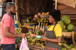 african woman selling in a market collecting credit card