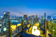 Bangkok City View Point From Rooftop Bar, Overlooking A Magnificent Cityscape Blue Sky And City Light, Thailand		