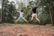 © ADDICTIVE STOCK - Unrecognizable excited siblings jumping above land in summer