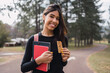 © ADDICTIVE STOCK - Young woman eating healthy snack in park