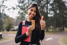 Happy Woman With Cereal Bar In Park