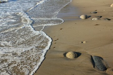 Poster - white foam from a wave lapping the coast