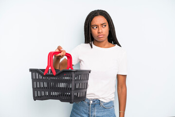 Wall Mural - black pretty woman feeling sad, upset or angry and looking to the side. empty shopping basket