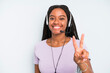 black pretty woman smiling and looking happy, gesturing victory or peace. telemarketer concept