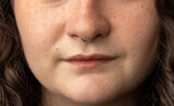Fototapeta Miasto - Close up of beautiful young woman with septum nose piercing
