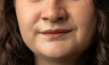 Fototapeta Miasto - Close Up of young woman turning up her nose