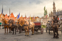 Bruges Market Square With Flemish Architecture And Horse Carriages, Belgium