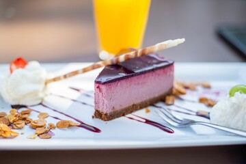 Canvas Print - Closeup shot of a delicious blueberry cheesecake on a plate decorated with whipped cream