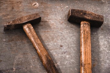 Wall Mural - Closeup of rusty hammers on a wooden surface