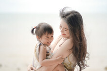Soft And Blurred Portrait Of Asian Young Woman And Her Daughter Hugging And Laughing Together. Lovely Family Concept.