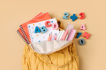 Wall Mural - Opened School backpack with stationery. Primary school or preschool, kindergarten. Kids Backpack on beige background.