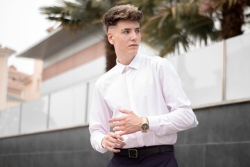 Handsome young business boy posing on a street