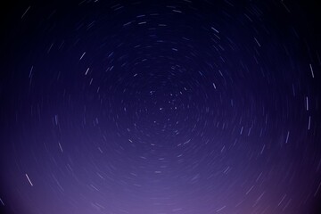 Wall Mural - long exposure to the stars in the night sky, gives the imitation of rotating earth