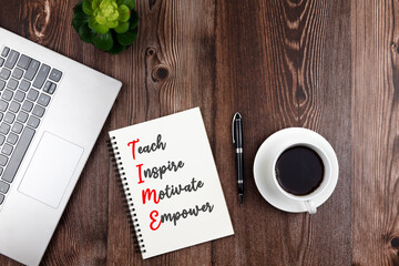 Wall Mural - TIME acronym Teach, Inspire, Motivate, Empower text on notepad with cup of coffee and laptop flat lay