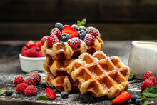 Belgian Waffles Sweet Desert With Raspberries, Strawberries And Blueberries, Sugar Powder