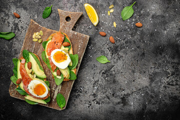 Wall Mural - Delicious breakfast or snack whole grain bread with avocado paste and salmon. keto paleo diet. banner, menu, recipe place for text, top view
