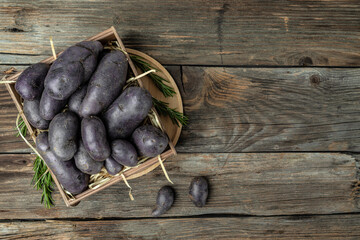 Wall Mural - Purple sweet potatoes on wooden background, Batata potato. vegan food ingredient. banner, menu, recipe place for text, top view