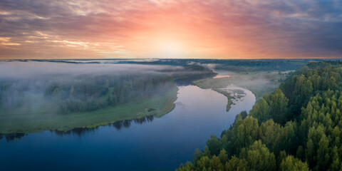 Aufkleber - Summer dawn over foggy forest and river aerial drone view. Aerial panoramic landscape with sunset over the river and beautiful clouds on the sky.
