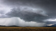 Destructive supercell storm bringing rain and wind over the farm field