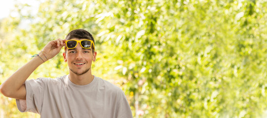 Poster - portrait of young man with sunglasses outdoors