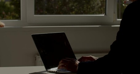 Poster - The worker sits at the computer desk. He types text with his hands, adjusts the monitor. The use of technology in the transmission and accumulation of information. The beginning of the work day. 