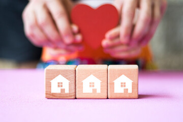 Poster - Businessman hand arranging wood block stacking with home icon business.