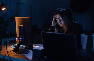 Poster - cybercrime, hacking and technology concept - female hacker in dark room writing code or using computer virus program for cyber attack