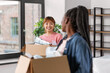 © Syda Productions - moving, people and real estate concept - happy smiling women with boxes at new home