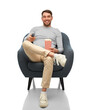 © Syda Productions - people and leisure concept - happy smiling man with tv remote control and popcorn sitting in chair over white background