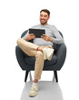 Leinwandbild Motiv people, technology and furniture concept - happy smiling man with tablet pc computer sitting in chair over white background