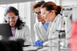© Syda Productions - science research, work and people concept - international team of scientists with laptop computer working in laboratory
