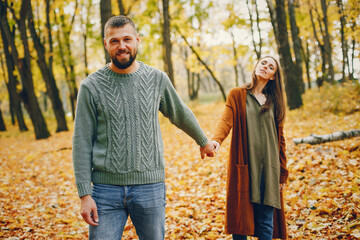 Wall Mural - Beautiful couple spend time in a autumn park