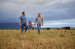 © Nina Lawrenson/peopleimages.com - Farmer family walking on a cattle or livestock farm teaching and learning together. Generations of a happy father, grandfather and grandchild bonding on sustainability agriculture land