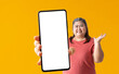Happy asian fat woman holding big smartphone on yellow background, isolated Clipping paths for design work empty free space mock up product display presentation.
