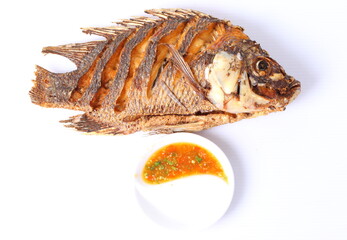 fried fish isolated with spicy sauce in white background