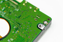 Closed Up Shot Of An Internal Hard Disk Electronic Board In Green Color.